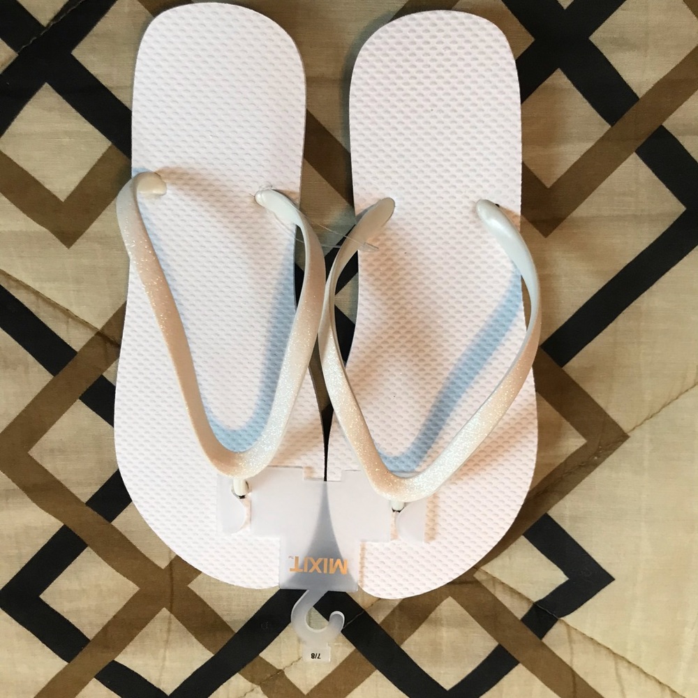 Two (2) pair. 1 pair white /1 pair brown Old Navy flip-flops.